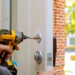 Residential locksmith installing child-safe lock on a door.